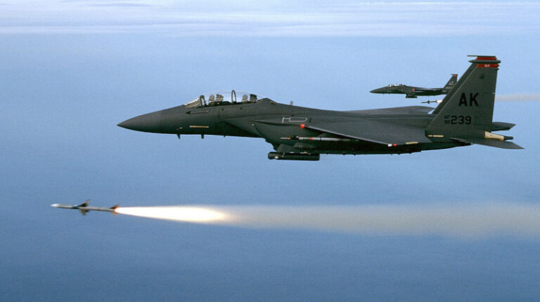 Two F-15Es from the 90th Fighter Squadron USAF fire a pair of AIM-7Ms during a training mission.